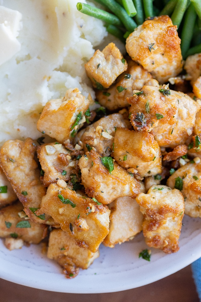 close up of garlic butter tofu with fresh herbs