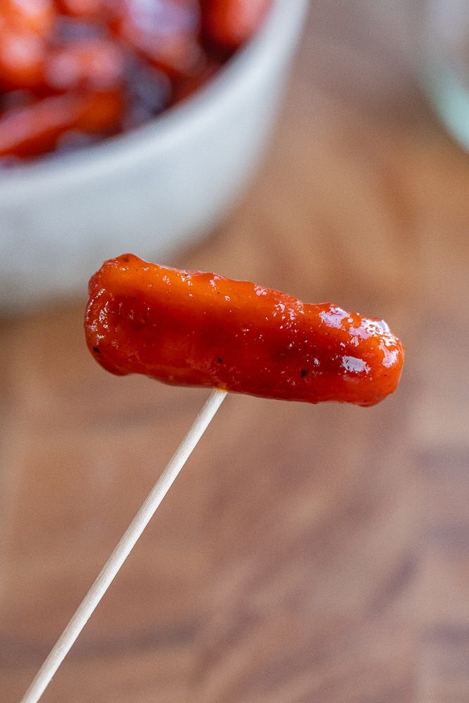 close up of a baby carrot little smoky on a toothpick