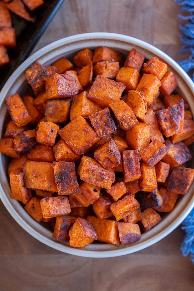 A bowl full of seasoned and roasted sweet potatoes