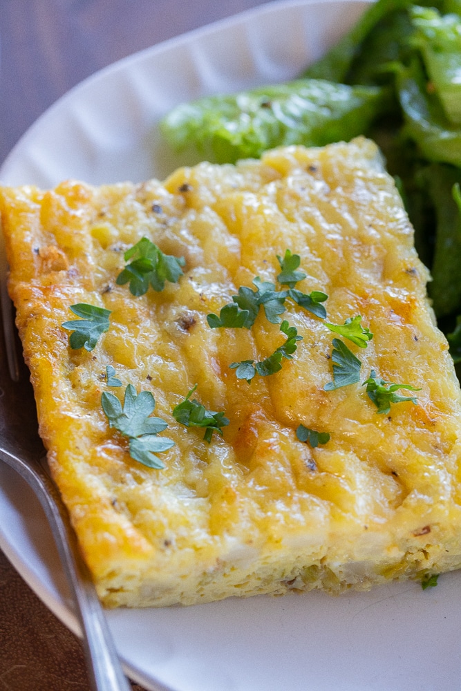 close up of a slice of vegetarian cauliflower egg bake on a plate