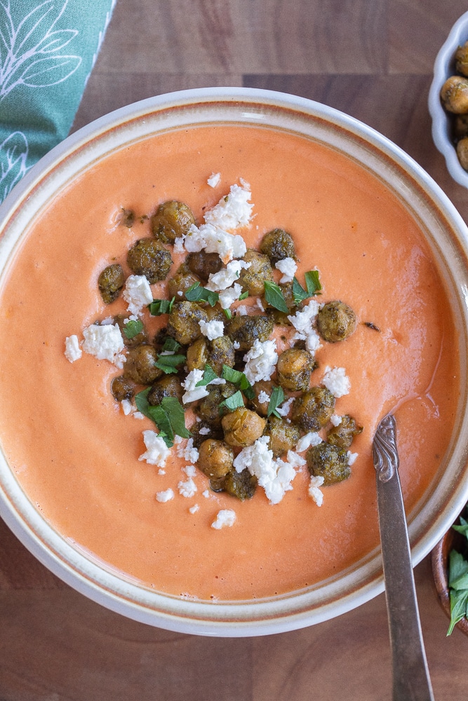 bowl of tomato feta soup topped with crispy pesto chickpeas
